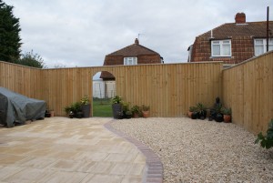 Gar1.8m and 2.1m high closeboard with archwayden fence panels